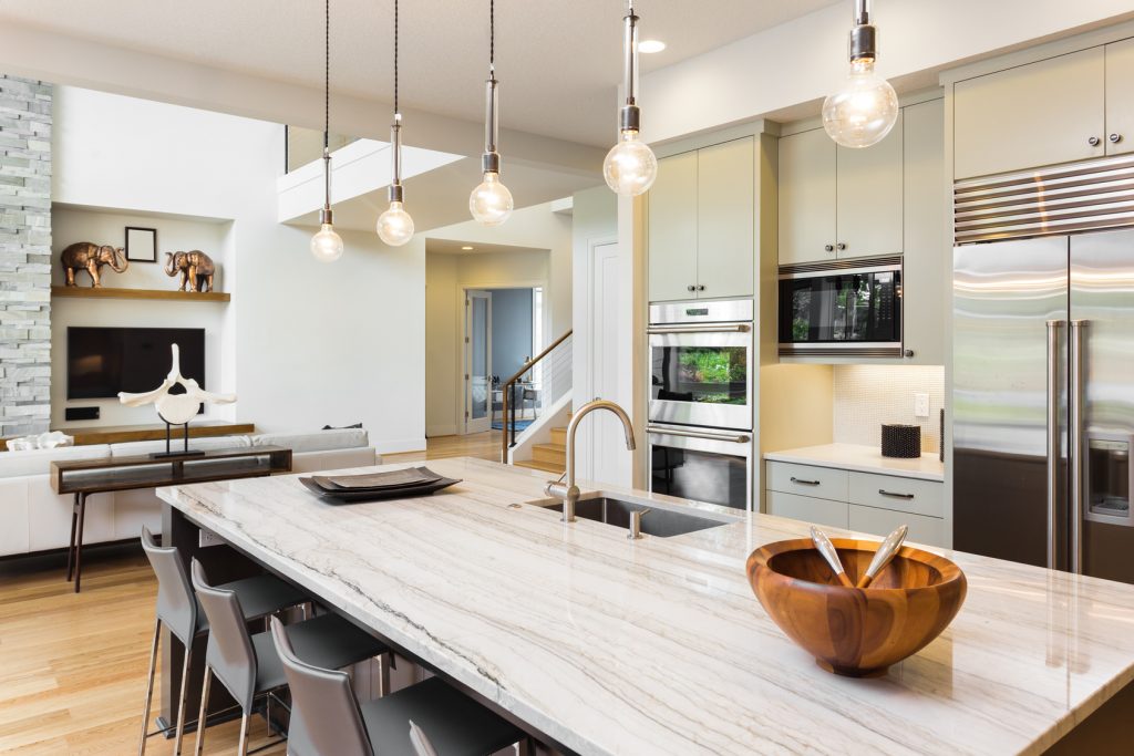 Kitchen with Island, Sink, Cabinets, and Hardwood Floors
